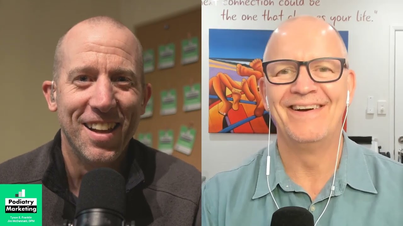 a man smiling next to a man with a microphone